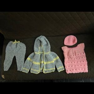 Two set of Crocheted baby clothes for a girl.